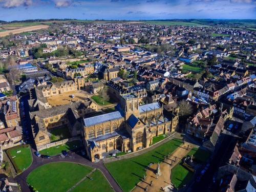 an aerial view of a large building in a city at The Plume of Feathers in Sherborne