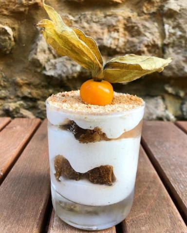 a drink with a cherry on top on a wooden table at The Plume of Feathers in Sherborne