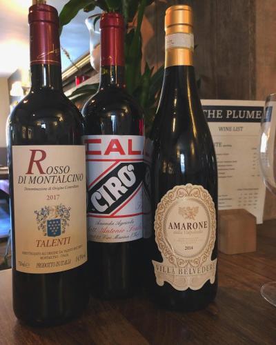 three bottles of wine sitting on top of a table at The Plume of Feathers in Sherborne