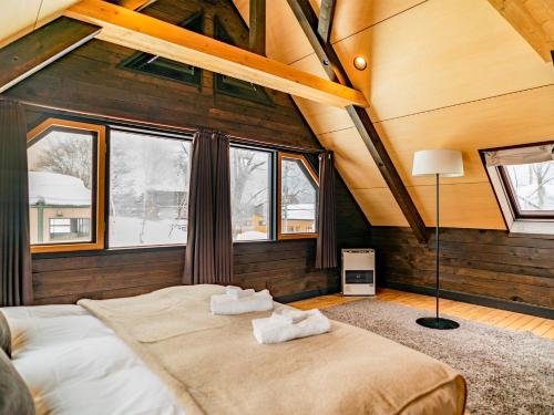 a bedroom with a large bed in the attic at Momiji Lodge in Niseko
