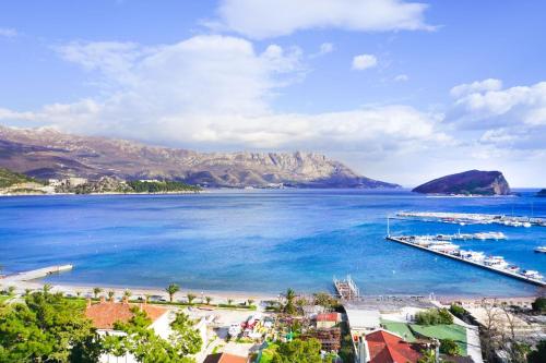 a view of a beach with boats in the water at Four Views Apartments in Budva