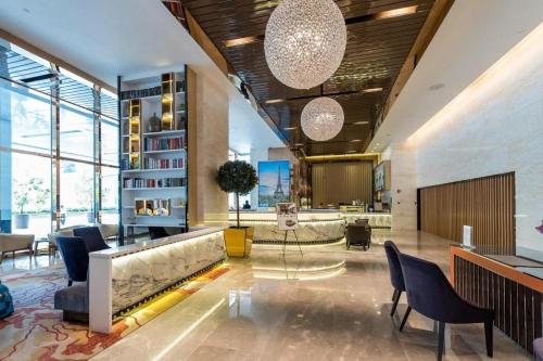 a lobby with a couch and chairs in a building at Platinum Serviced Suite KLCC in Kuala Lumpur