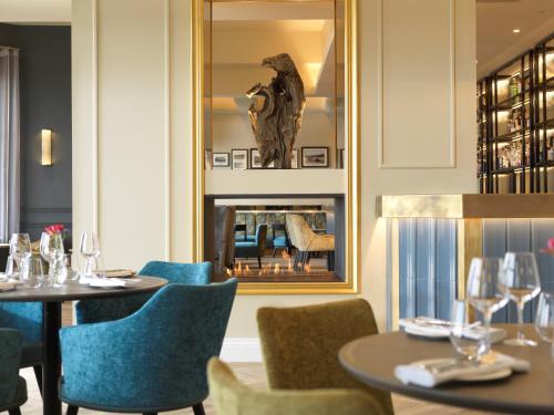 a restaurant with a table and chairs and a fireplace at Clifton Arms Hotel in Lytham St Annes