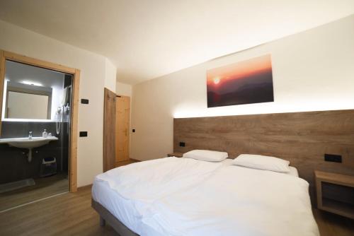 En eller flere senge i et værelse på Hotel Zanella