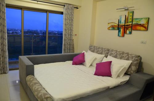 a large bed in a room with a large window at Atrium - ICONIC APARTMENT in Sri Jayewardenepura Kotte