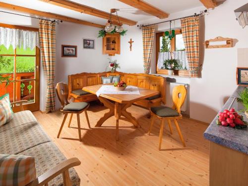 a living room with a wooden table and chairs at Haus Michinglehen in Marktschellenberg