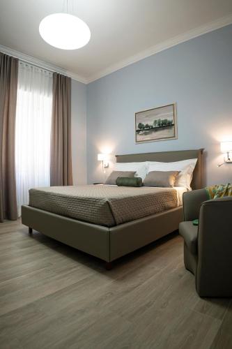 a bedroom with a large bed and a couch at Azzurro 6 Holiday House in Martina Franca