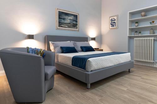 a bedroom with a bed and a chair at Azzurro 6 Holiday House in Martina Franca