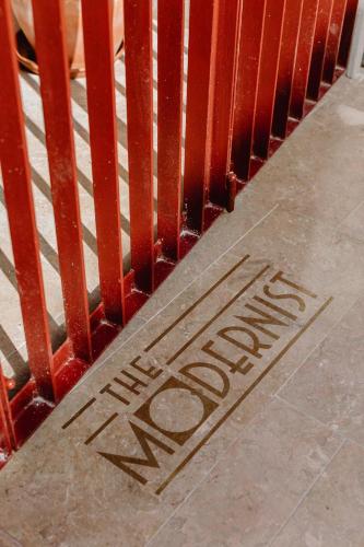 a sign on the floor with the word danger on the sidewalk at THE MODERNIST, Architecture experience in Faro