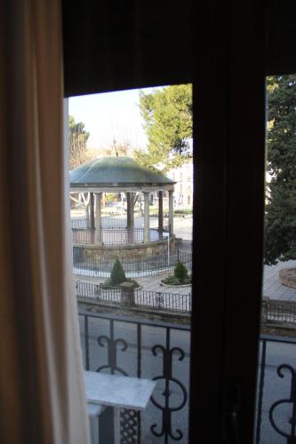 a view of a gazebo from a window at Hostal Poeta Machado in Baeza