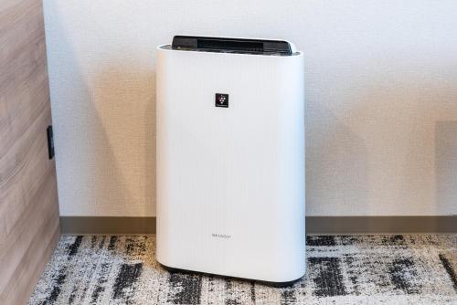 a cell phone sitting on top of a white refrigerator at Hotel Kazusaya in Tokyo
