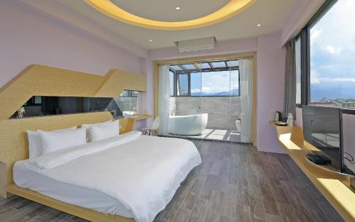 1 dormitorio con 1 cama grande y TV en Sunny Stream B & B, en Wujie