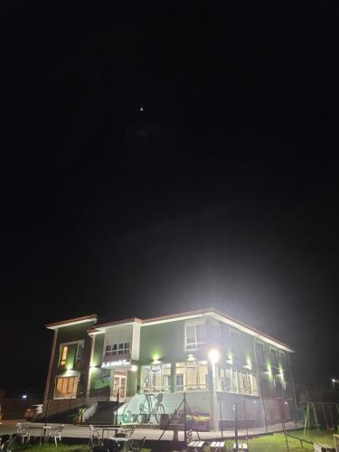 a building at night with lights in front of it at Hotel Restaurante el Fornon in Novellana