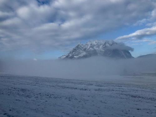 a mountain in the middle of the ocean with clouds at Apartment Fewo Irdning Pichlarn in Aigen im Ennstal