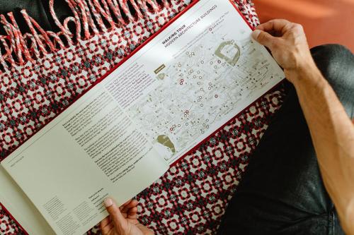 a person reading a book with their hands at THE MODERNIST, Architecture experience in Faro