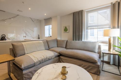 a living room with a couch and a table at No1 Apartments & Bedrooms St Andrews - St Mary's in St. Andrews