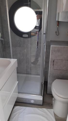 a bathroom with a shower and a toilet and a sink at La Mare Resort in Gothenburg