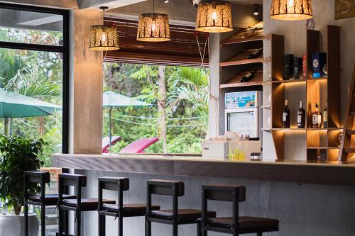 a bar with a row of stools in a restaurant at Kampot Sweet Boutique in Kampot