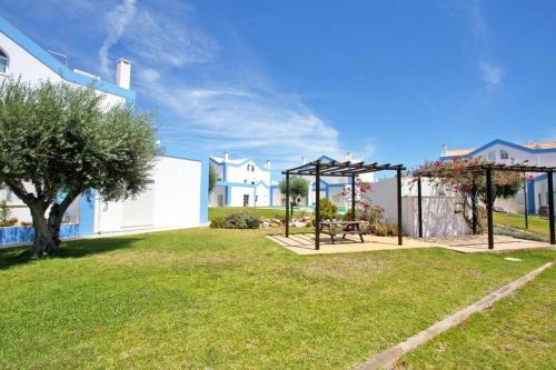 a park with a picnic table and a swing at CASA ALFARROBA, QUINTA DO PEROGIL, TAVIRA, ALGARVE in Tavira