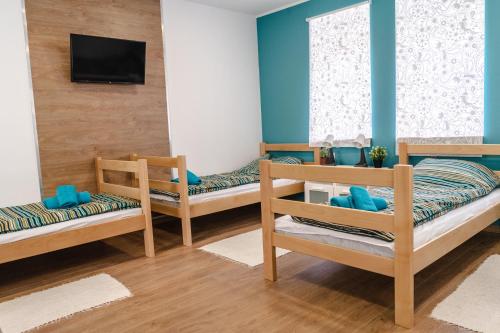 a room with three bunk beds and a tv at Urban House - Ada in Ada