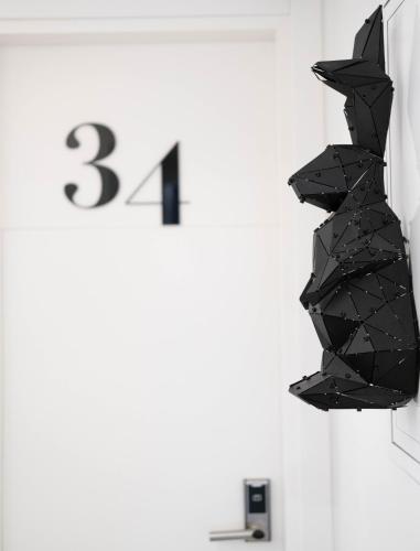 a black sculpture of a cat hanging on a wall at The Westist Hotel & Spa - Special Category in Istanbul