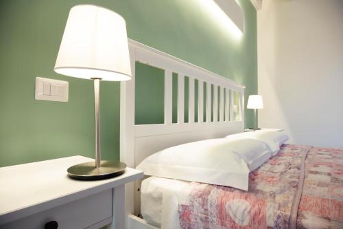 a bedroom with a bed with a lamp on it at La corte di Emma e Ale in Volta Mantovana