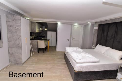 a bedroom with a large bed and a kitchen at Little sofia hotel in Istanbul