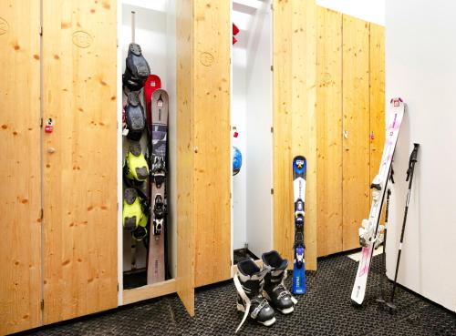 a bunch of skis and ski equipment in a room at Hôtel Club mmv Le Val Cenis *** in Lanslebourg-Mont-Cenis