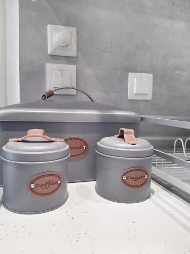 two grey containers sitting on top of a counter at 50 meters by the beach - Maria Paradise in Polychrono