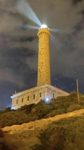 a lighthouse with a light on top of it at Hotel Madrid in Santiago de la Ribera