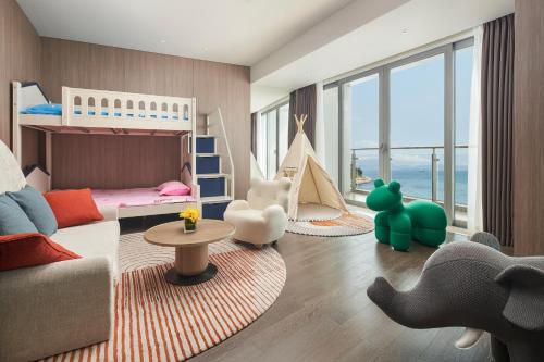 a childrens room with a bunk bed and a couch at Intercontinental Shenzhen Dameisha Resort by IHG in Shenzhen