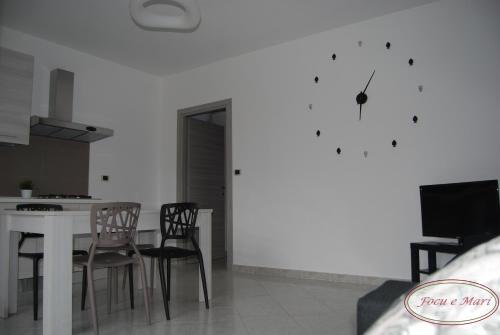 a kitchen and dining room with a table and chairs at Focu e Mari in Mascali