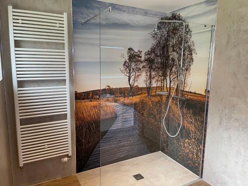 a bathroom with a shower with a painting of a walkway at Haus Wunschlos Auf Aderich in Monschau
