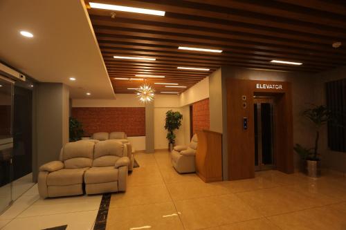 a lobby with a waiting room with reclining chairs at Bhavanam Regency Guruvayoor in Guruvāyūr