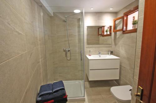 a bathroom with a shower and a sink and a toilet at Marbat in Port de Soller