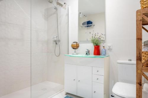 a bathroom with a shower and a sink and a toilet at Casa Sunny in Port de Soller