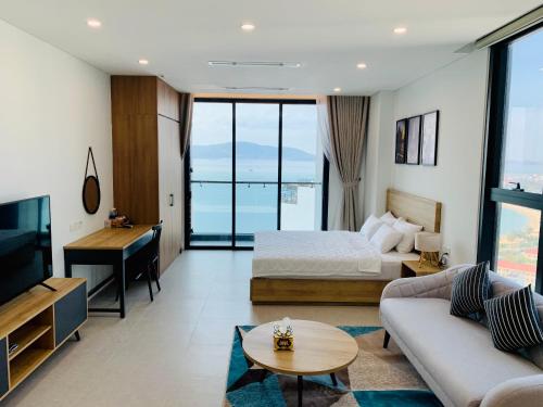 a hotel room with a bed and a couch at Wise Stay Scenia Bay Apartment in Nha Trang
