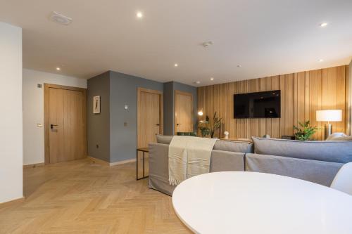 a living room with a couch and a table at No1 Apartments & Bedrooms St Andrews - St Mary's in St. Andrews