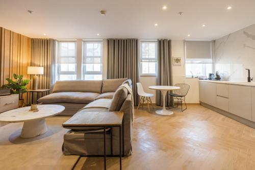 a living room with a couch and a table at No1 Apartments & Bedrooms St Andrews - St Mary's in St. Andrews