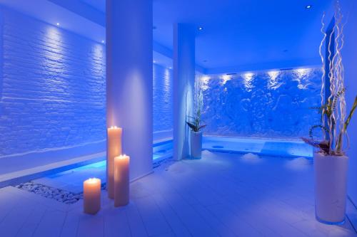 a room with a pool with candles and a window at Hotel Regina Elena 57 & Oro Bianco SPA in Rimini