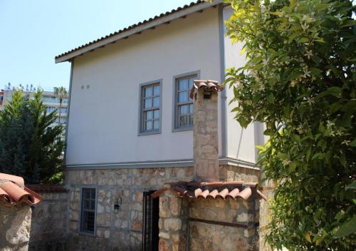 a house with a chimney on top of a stone wall at VILLA CASTLE INN in Antalya