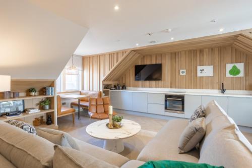 a living room with a couch and a table at No1 Apartments & Bedrooms St Andrews - St Mary's in St. Andrews