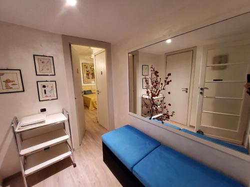 a room with a blue couch and a large mirror at Annadia Sweet Home B&B in Lido di Ostia