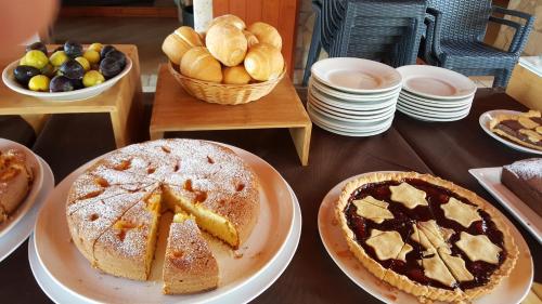 a table topped with plates of desserts and pies at Agriturismo I Tesori del Sud Vieste, Puglia in Vieste