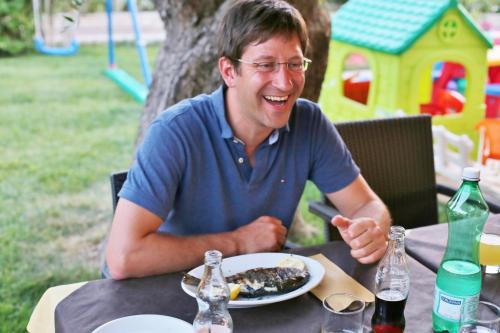a man sitting at a table with a plate of food at Agriturismo I Tesori del Sud Vieste, Puglia in Vieste