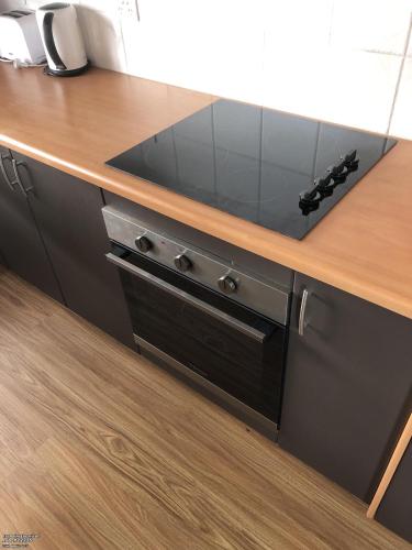 a kitchen counter with a black stove top oven at Province in Portland