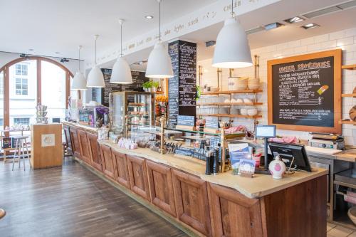 a restaurant with a large counter with a counter sidx sidx at Altstadt Hotel & Café Koblenz in Koblenz