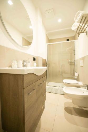 a bathroom with a sink and a toilet and a mirror at HOME CARPEDIEM in Verona
