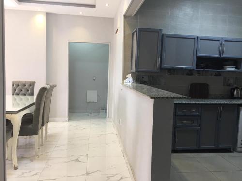 a kitchen with a table and a dining room at Ramco For Furnished Apartments And Accommodation Compound Leila in Cairo