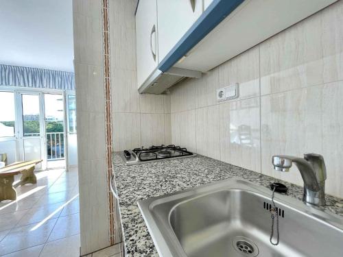 a kitchen with a sink and a stove at GoettenMar Platja d'Aro in Platja  d'Aro